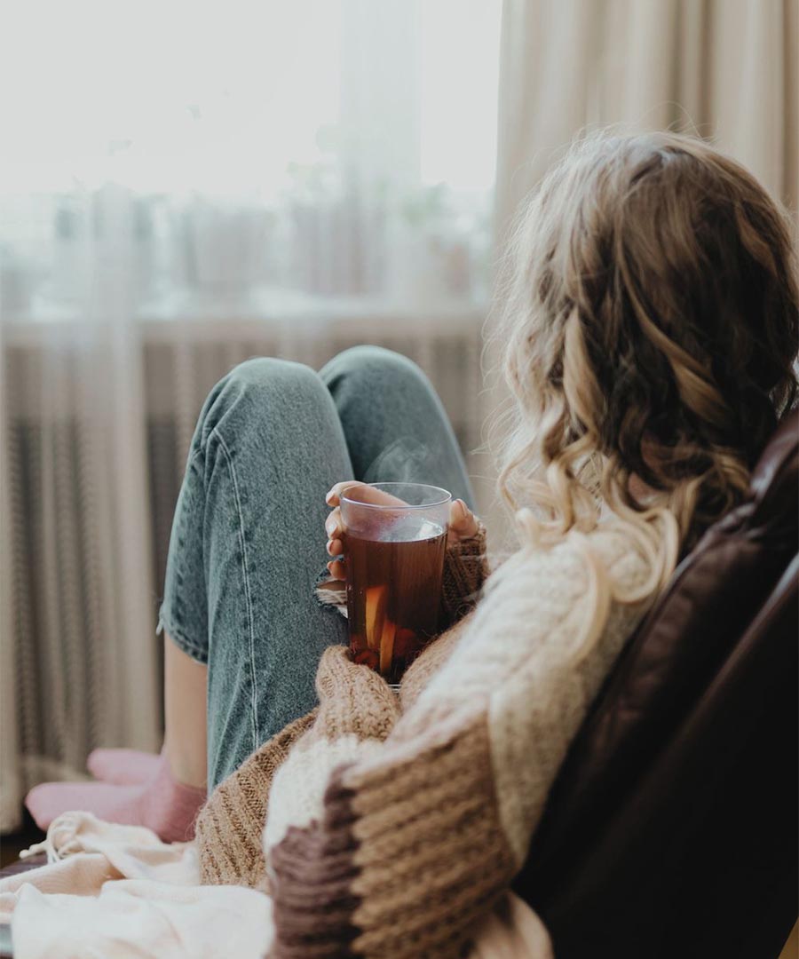 Girl smells sunflower in nature